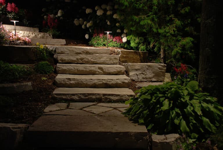 Outdoor lighting - stone steps with greenery.