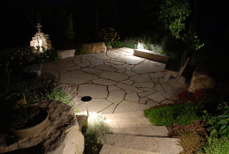 Outdoor lighting - stone ground and steps with greenery.