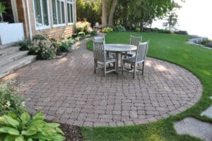 Stone backyard deck with table and chairs