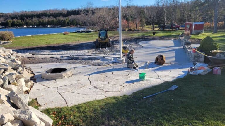 Meissner employees installing stone fireplace and walkway.