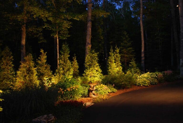 Outdoor lighting, lit up greenery and driveway.