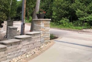 Stone wall built next to driveway.